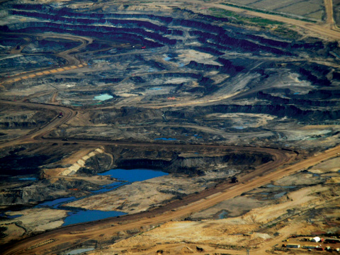 Gates is a major investor in Canadian National Railroads, which transports crude oil from Canada’s tar sands Aerial photograph of tar sands fields in Canada